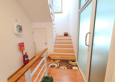 Bright staircase area with wooden steps and modern decor