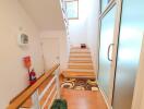 Bright staircase area with wooden steps and modern decor