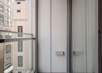 Narrow balcony with wooden flooring and glass railing