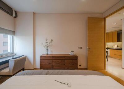 Modern bedroom with a view into the kitchen