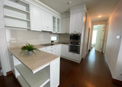 Modern kitchen with white cabinetry and built-in appliances