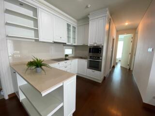 Modern kitchen with white cabinetry and built-in appliances