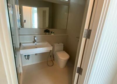 Modern bathroom with sink, mirror, and toilet