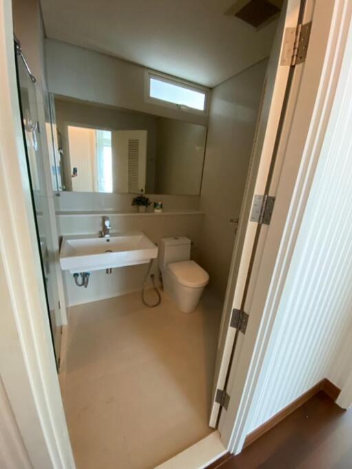 Modern bathroom with sink, mirror, and toilet