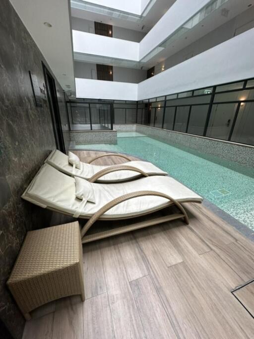 Indoor pool area with lounge chairs