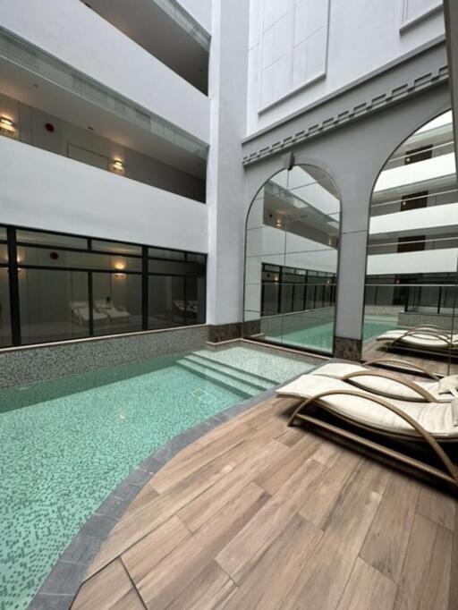 Indoor pool area with lounge chairs