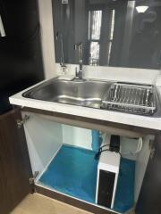 Under-sink area in kitchen with modern faucet