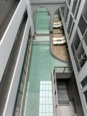 Indoor pool area with lounge chairs