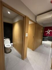 Modern bathroom view with toilet and wood-paneled walls