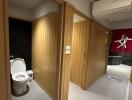 Modern bathroom view with toilet and wood-paneled walls