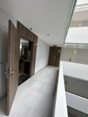 Bright modern hallway with wooden doors and open atrium