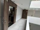 Bright modern hallway with wooden doors and open atrium