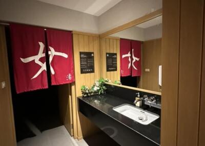 Well-lit bathroom with vanity mirror and sink