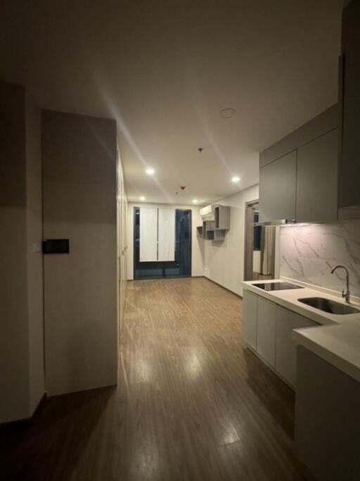 Modern kitchen with wooden flooring and ambient lighting