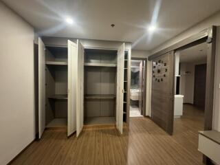 Bedroom with open closets and wooden floor