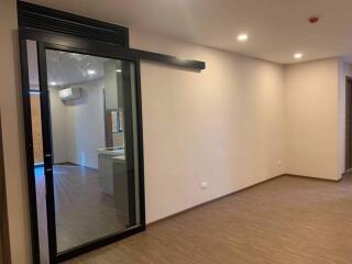 Modern main living area with sliding glass door and recessed lighting