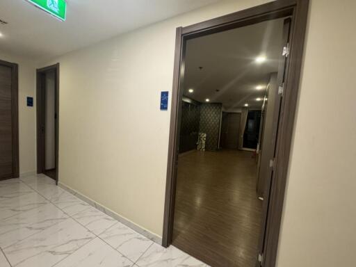 Hallway with tile and wooden flooring