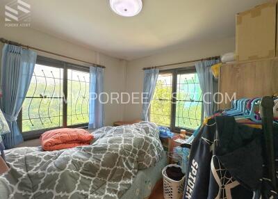 Bedroom with windows and bed