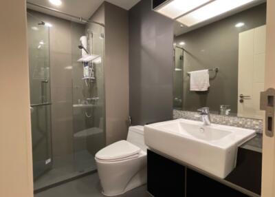 Modern bathroom with shower, sink, and toilet