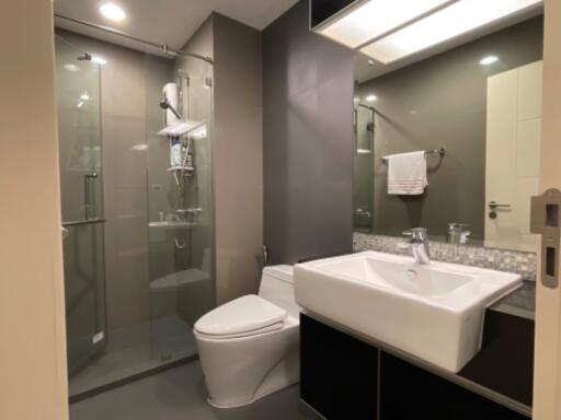 Modern bathroom with shower, sink, and toilet