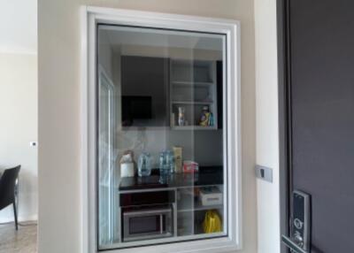 View of a compact kitchen through a window in a wall