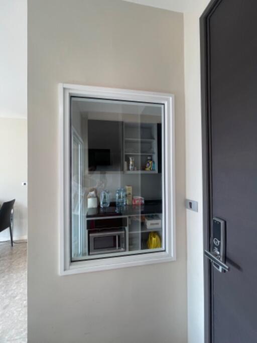 View of a compact kitchen through a window in a wall