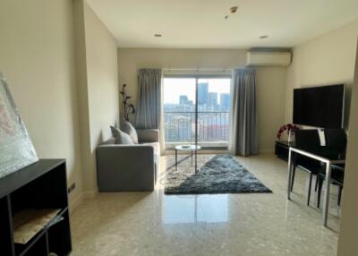 Spacious living room with modern furnishings and large window