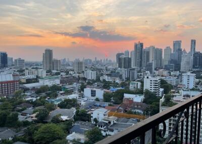 View of the city skyline from a balcony during sunset