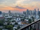 View of the city skyline from a balcony during sunset