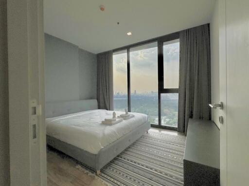 Modern bedroom with a large window offering a view