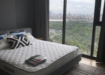 Bedroom with large windows and city view