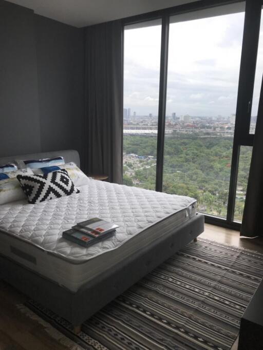 Bedroom with large windows and city view