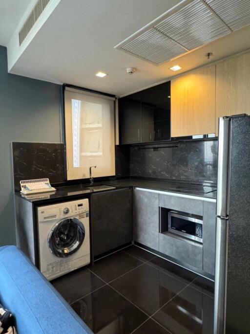 Modern kitchen with washing machine and microwave