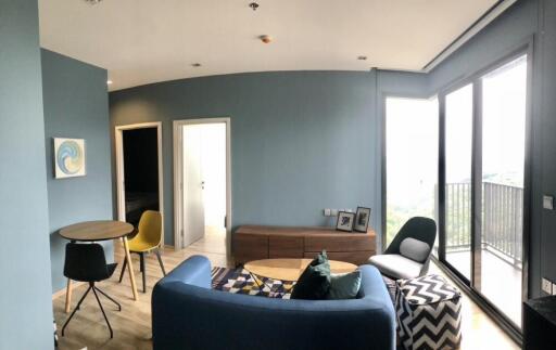 Modern living room with blue walls and large windows