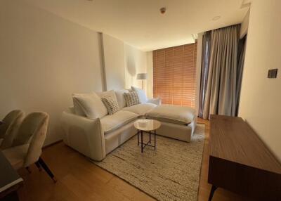 Modern living room with a large sectional sofa and floor-to-ceiling windows