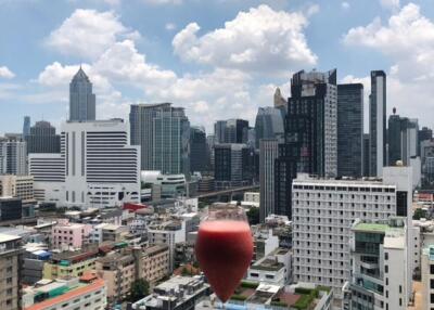 Urban view from balcony with a glass of wine