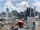 Urban view from balcony with a glass of wine