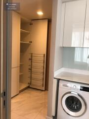 kitchen with washer and shelving unit