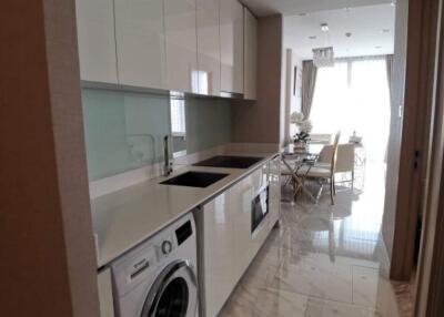 Modern kitchen with washing machine and dining area view