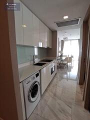 Modern kitchen with washing machine and dining area view