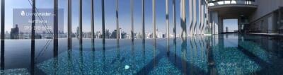 Skyline view from modern rooftop pool with clear blue water