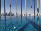 Skyline view from modern rooftop pool with clear blue water