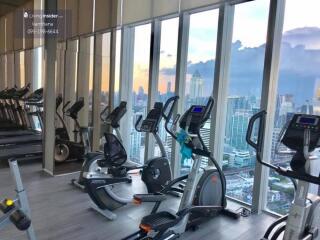 Fitness center with exercise equipment and city view