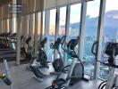 Fitness center with exercise equipment and city view