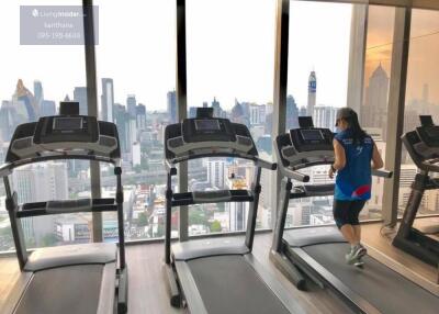 Gym with treadmills and a city view