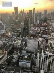 View of city skyline with numerous buildings during sunset