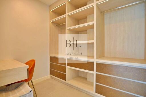 Spacious custom closet with wooden shelves and drawers