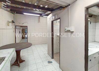 Kitchen area with tiled flooring and ceiling beams