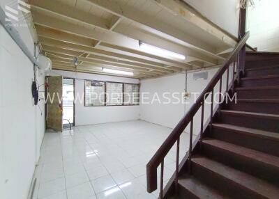 Spacious room with wooden staircase