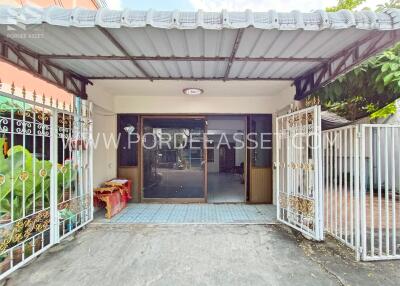 Front entrance of a building with a gate and canopy